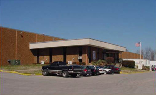 A large building with cars parked in front of it.