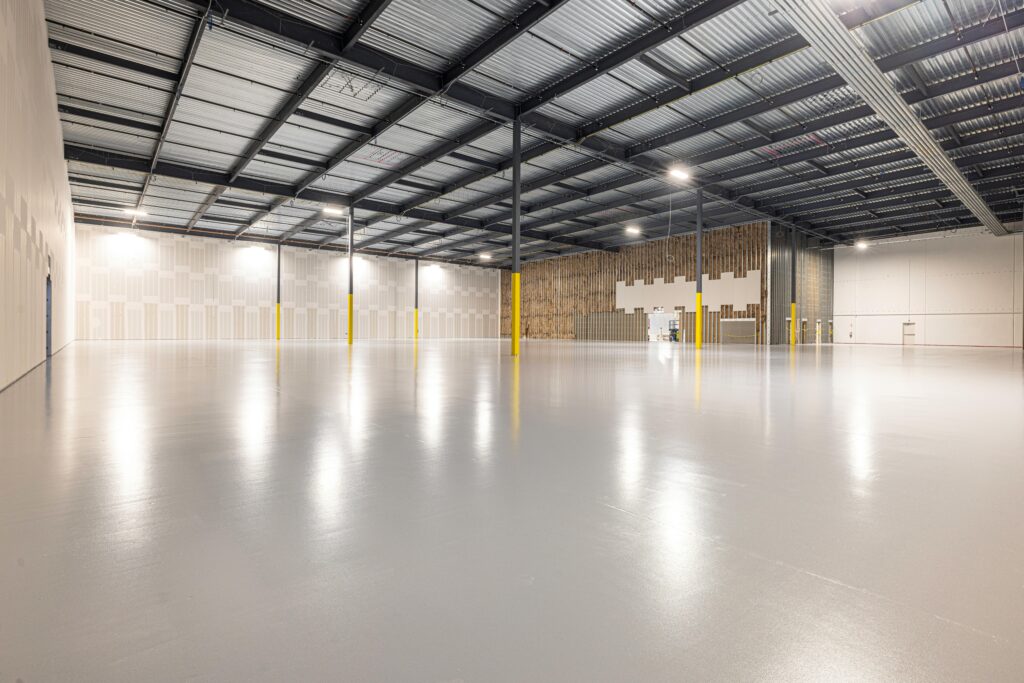 Empty modern warehouse interior with polished floor and ample space located in Texas.