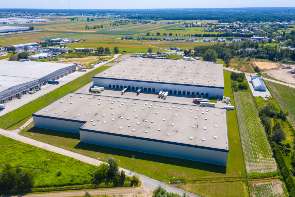 aerial,shot,of,industrial,warehouse,loading,dock,where,many,truck
